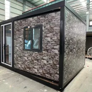 Side view of a 10FT camouflage expandable container home with insulated wall panels and flat roof