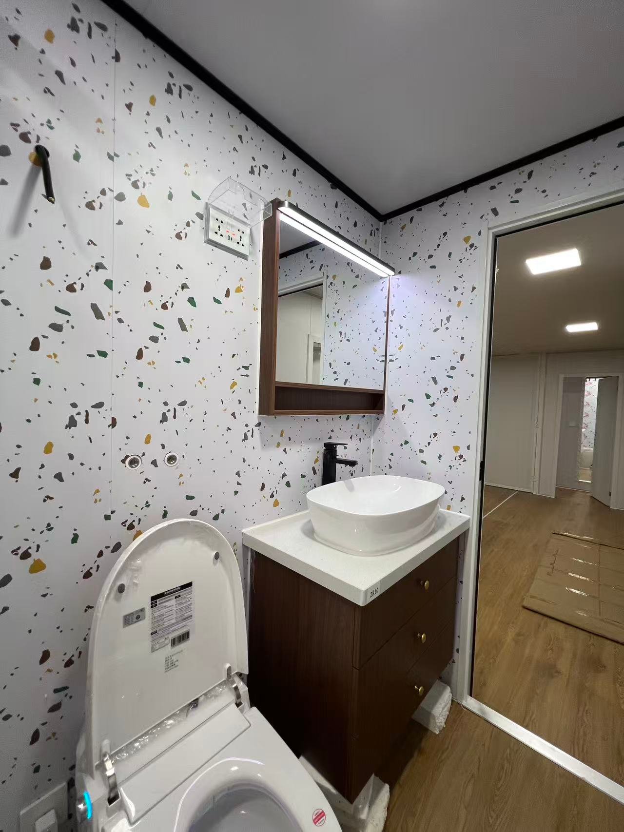 Modern bathroom interior of a 40FT container home with toilet and vanity