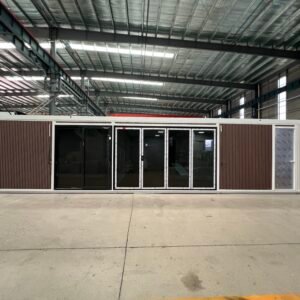 Front view of a 40FT expandable container house with decorative metal siding and large glass windows