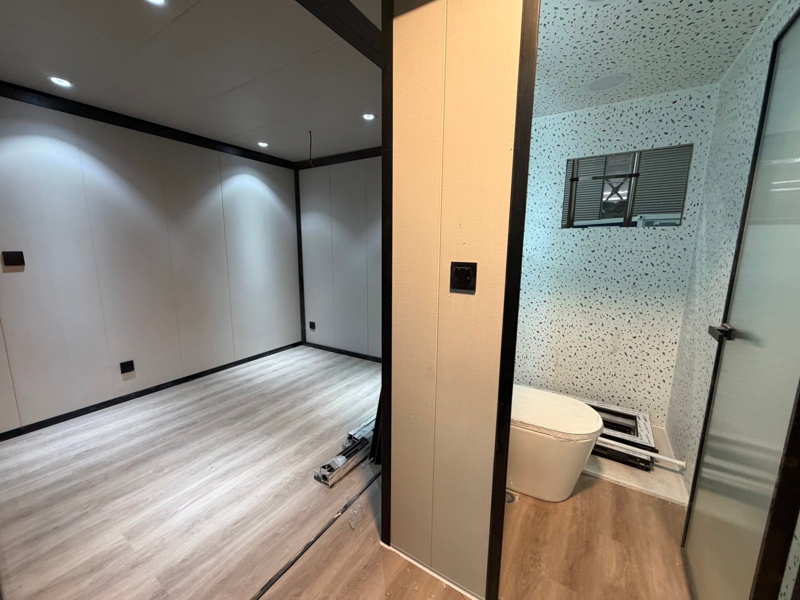 Toilet inside expandable container house with compact bathroom design