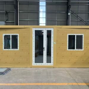 Front view of a lemon yellow expandable container house with a clean flat roof design