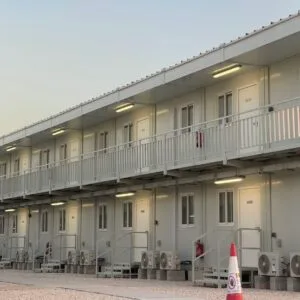 Multi-room prefab container building with exterior walkway