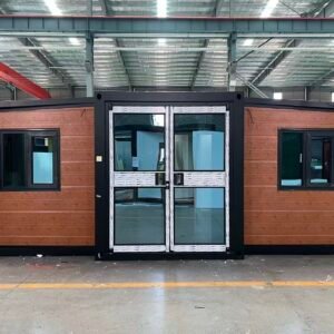 Front view of an orange expandable container house with a distinctive double-door entrance