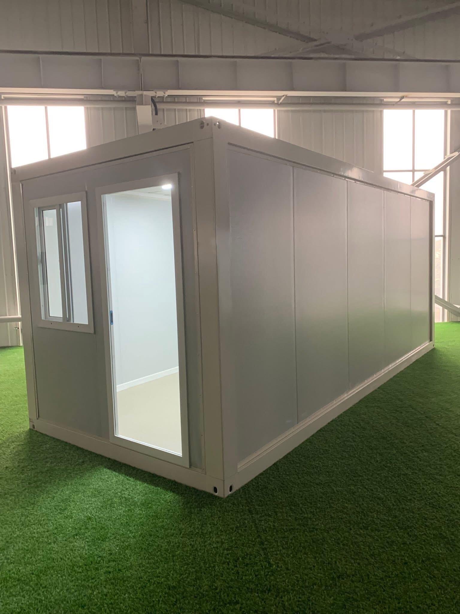 Portable packing container house with windows and entrance door