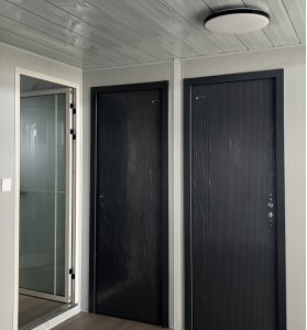 Standard interior door option for expandable container houses and prefab homes