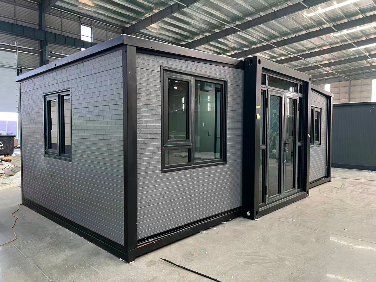 Side view of premium grey insulated expandable container house with galvanized steel frame