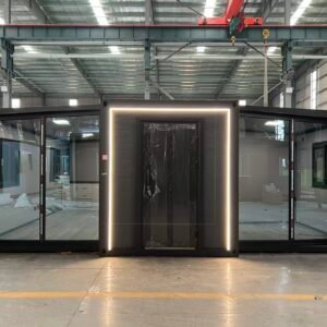 Front view of an expandable container house with a security entrance door and reflective floor-to-ceiling glass window