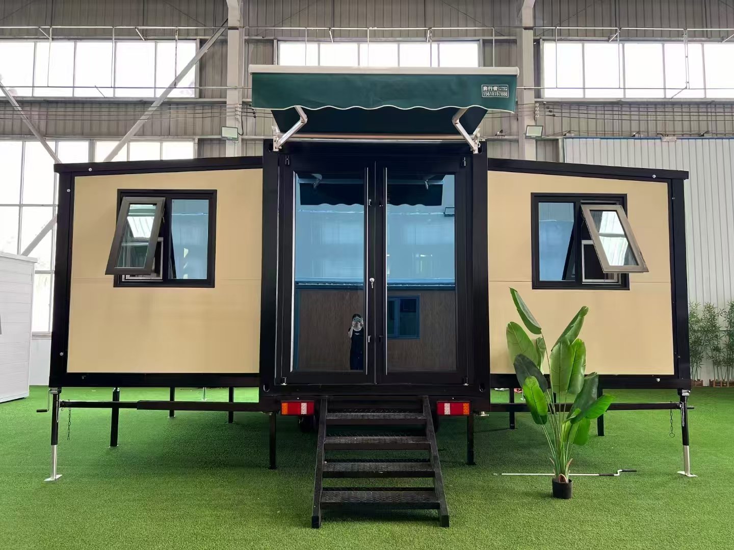 Front view of trailer-mounted expandable container house with mobile modular design
