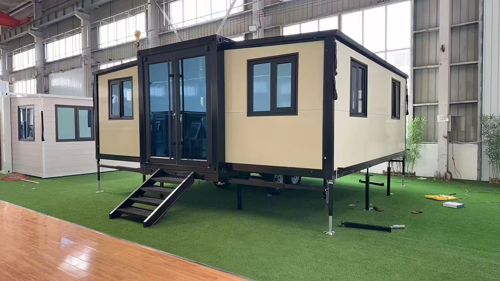 Side view of trailer-mounted expandable container house with wheels and expandable structure