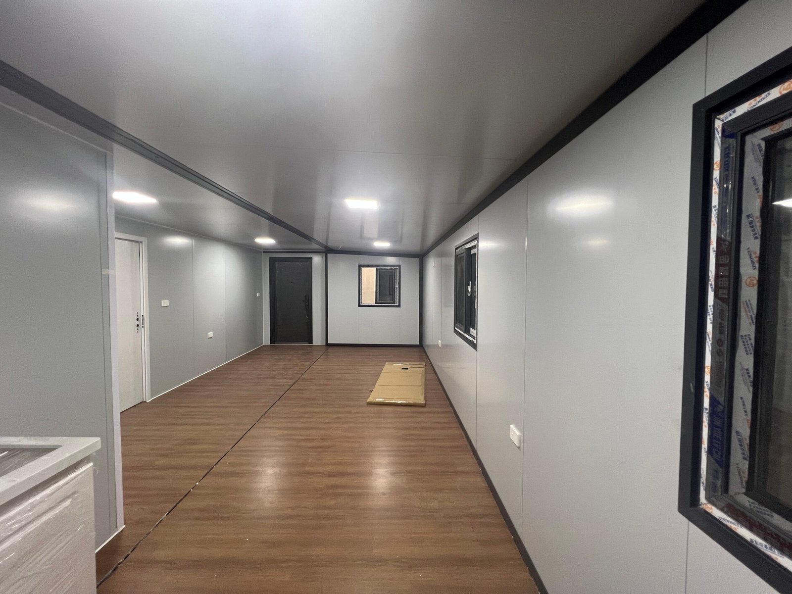 Seating room inside wind-resistant expandable container house with modern open living area