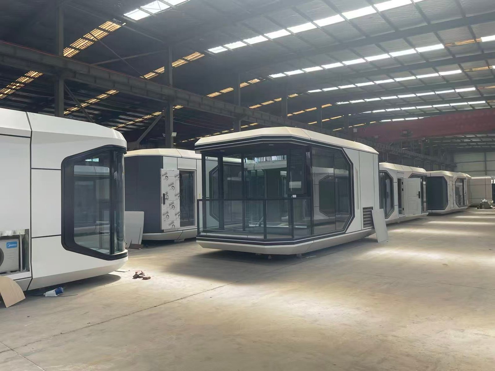 Batch stock of 23sqm Space Capsule glamping pods, multiple compact modular prefab houses inside workshop